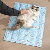Cat resting comfortably on a blue cooling gel mat