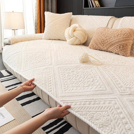 Beige plush sofa cover with an embossed geometric pattern