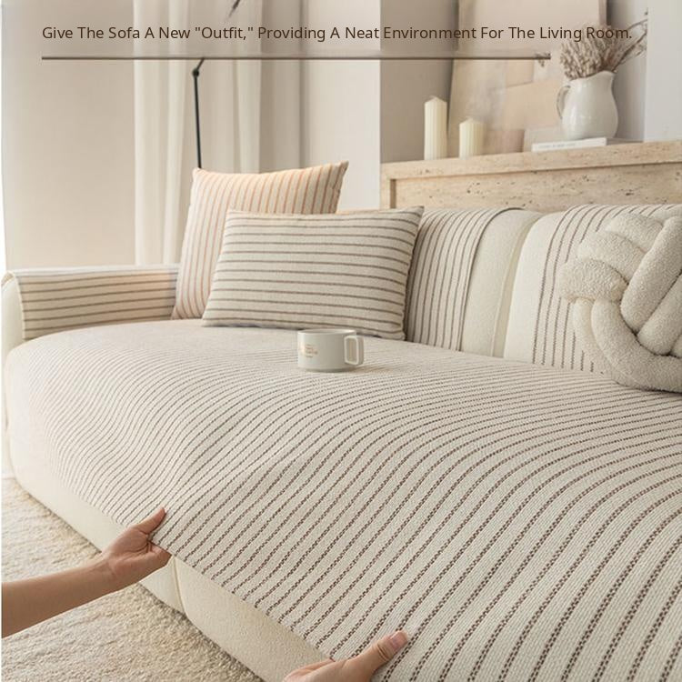 Lifting the pinstripe cover from the sofa seat — gsft-9058