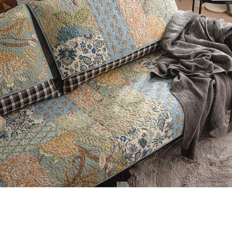 Quilted floral patchwork across the sofa seat — gsft-9060