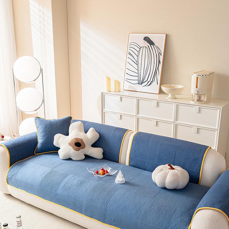 Blue quilted cover across a sofa seat — gsft-9065