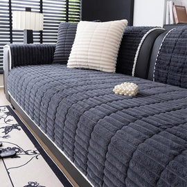 Dark gray ribbed plush fleece modular couch cover shown on a sofa