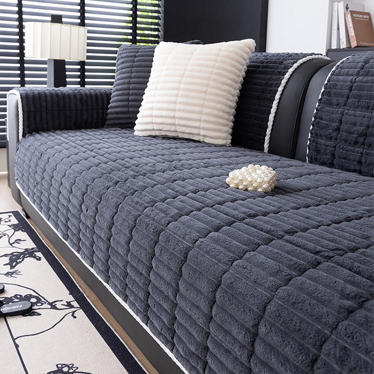 Dark gray ribbed plush fleece modular couch cover shown on a sofa