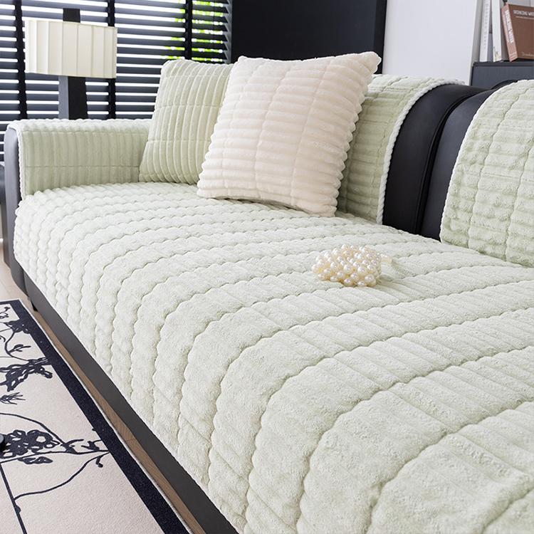 Light green ribbed plush fleece modular couch cover shown on a sofa