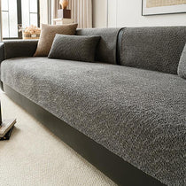 Black boucle-style chenille modular couch cover shown on a sofa