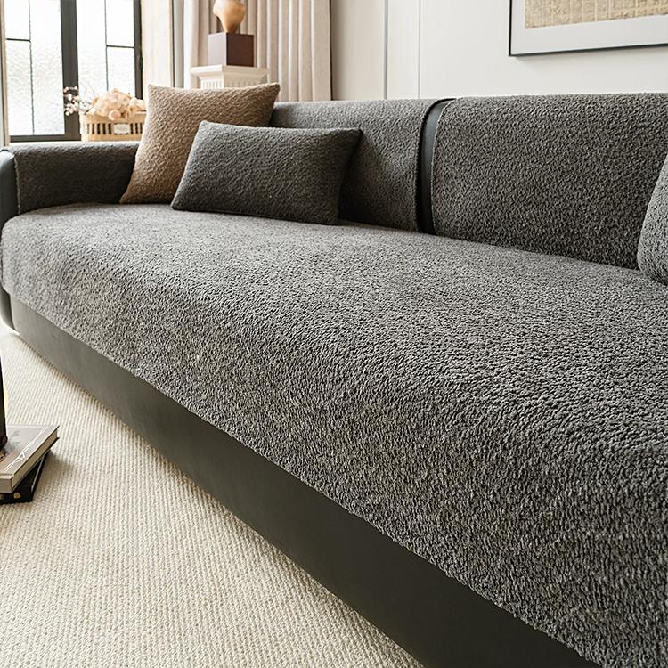 Black boucle-style chenille modular couch cover shown on a sofa