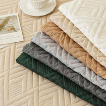 Water-Resistant Geometric Quilted Couch Cover detail showing the water-resistant surface
