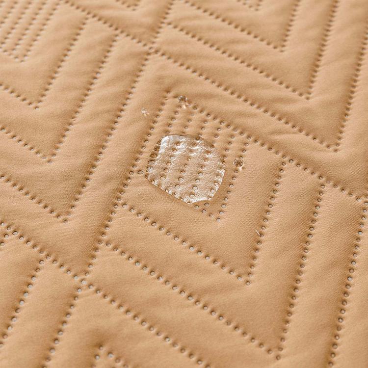 Water-Resistant Geometric Quilted Couch Cover detail showing the coordinated color selection