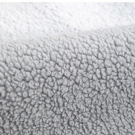 Cozy Faux Sherpa Couch Cover detail showing the finished edge and accent label