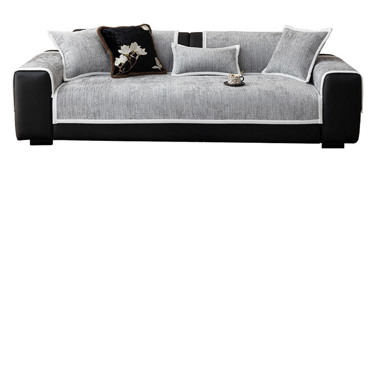 Gray modular chenille cover arranged across a sofa