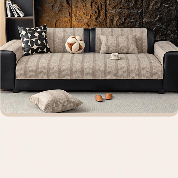 Neutral herringbone couch cover across a modern sofa