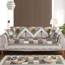 Patchwork cotton couch cover arranged on a sofa