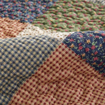 Layered patchwork patterns on a sofa
