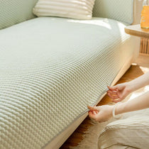 Hands securing the modular ice silk sofa cover
