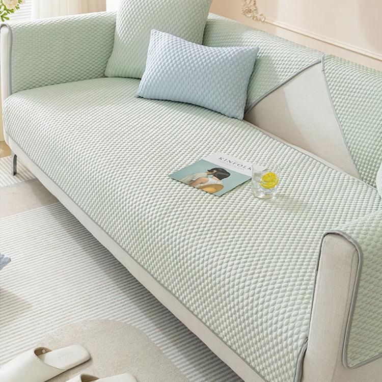 Green honeycomb couch cover on a modern sofa