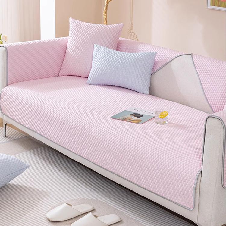 Pink honeycomb couch cover on a sofa