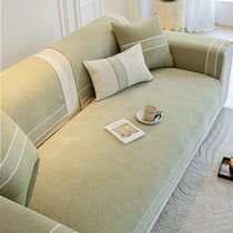 Green modular couch cover in a bright living room