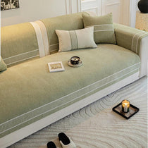 Green bordered couch cover with matching cushions
