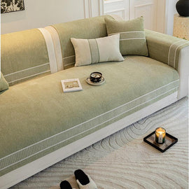 Green bordered couch cover with matching cushions