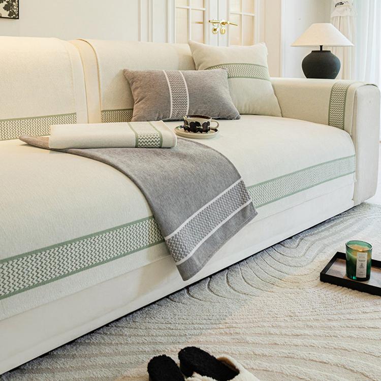 Gray bordered couch cover in a neutral room