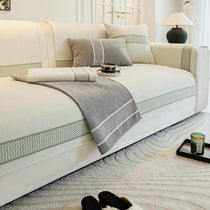 Gray bordered couch cover in a neutral room
