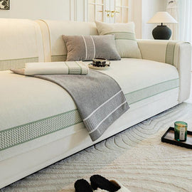 Gray bordered couch cover in a neutral room