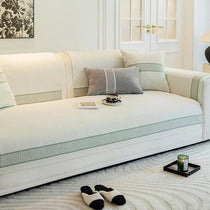 White bordered cover across the sofa seat