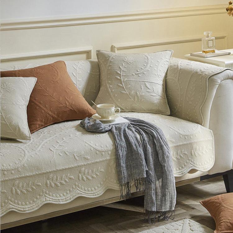 Scalloped botanical cotton non-slip couch cover styled on a sofa