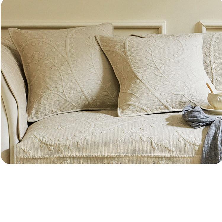 Beige botanical couch cover styled with cushions