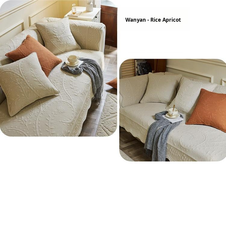 Beige couch cover with orange accent cushions