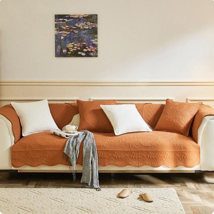 Orange botanical couch cover across a sectional