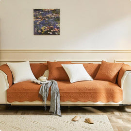 Orange botanical couch cover across a sectional