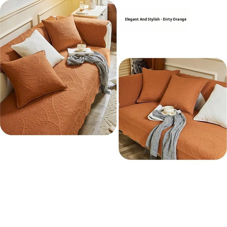 Orange couch cover with matching textured cushions