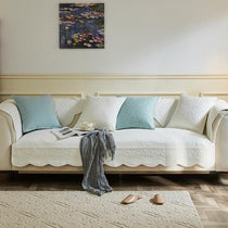 White botanical couch cover styled on a long sofa