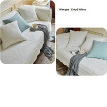 White couch cover with a light blue accent cushion