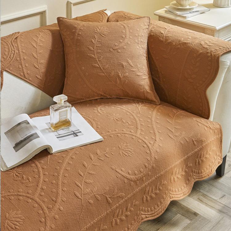 Orange botanical cover on a compact sofa