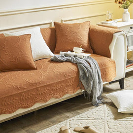 Orange couch cover with a scalloped front edge