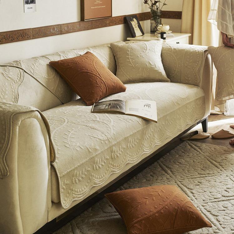 Beige botanical couch cover in a neutral room